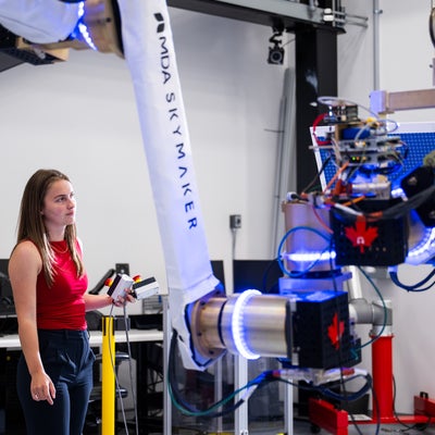 Mary McPhee testing part of the MDA Skymaker prototype robotic arm