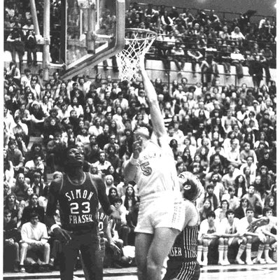 Waterloo Warriors player Jeff Scott tries to make a layup during a basketball game 