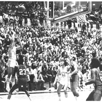 Phil Goggins throws a basketball during a championship game
