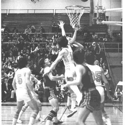 Waterloo Warriors players jump up to defend the opposing player's shot during a game