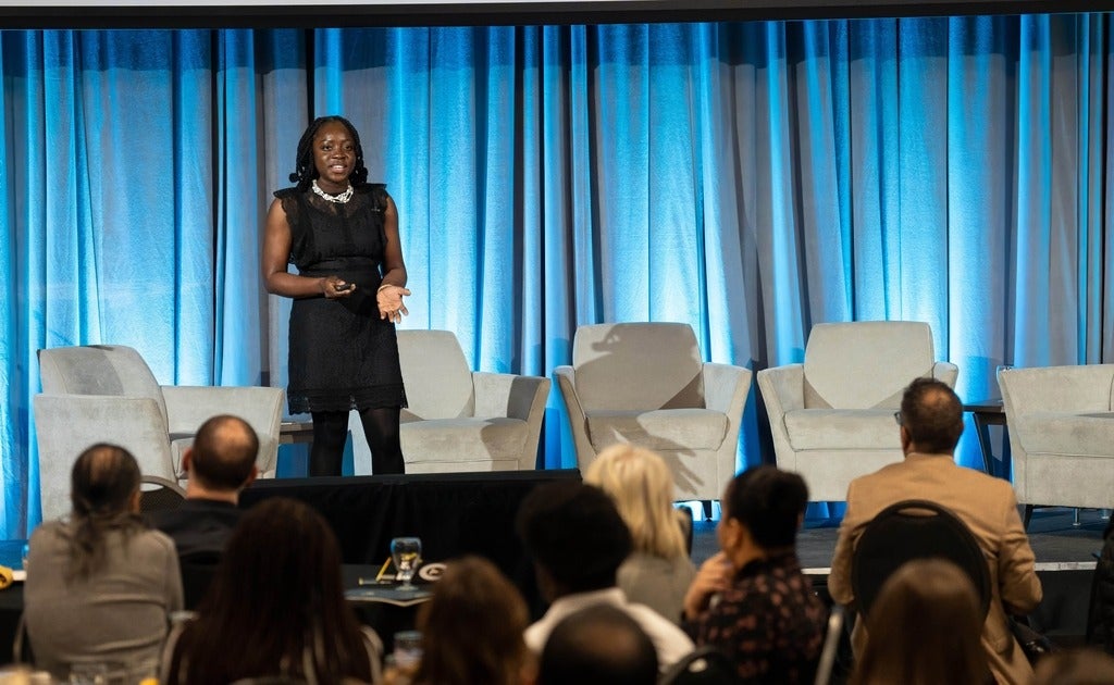 MedInclude founder Seun Adetonji presents to an audience from the main stage at the Global Futures launch in January 2024