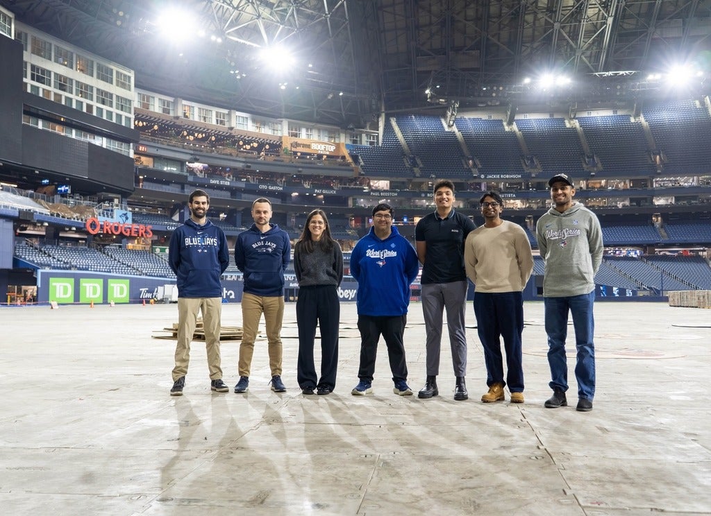 Group poses together on field level at Rogers Centre