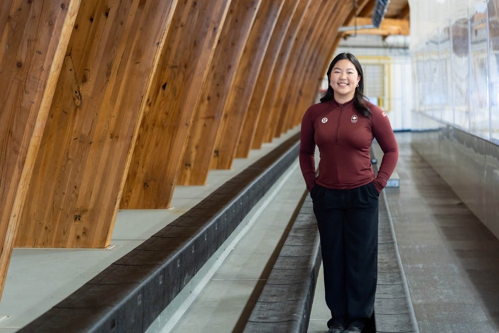 Diane Choi stands in the Columbia Ice Fields rink stands while wearing COC gear
