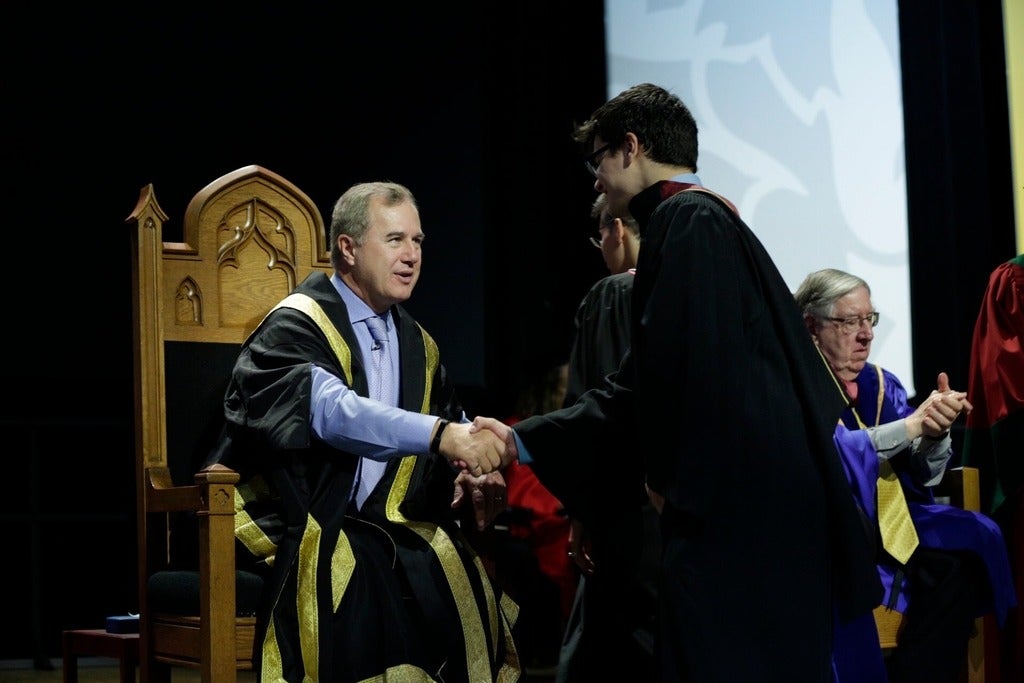 Jenkins congratulating a student