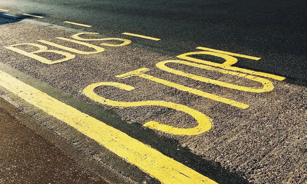 bus stop printed on asphalt (photo by Suzy Hazelwood)