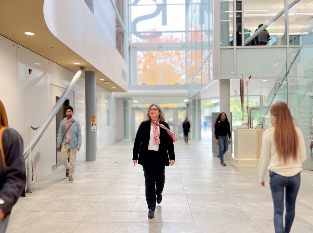 Dr. Carla Fehr walking in a hallway in Hagey Hall
