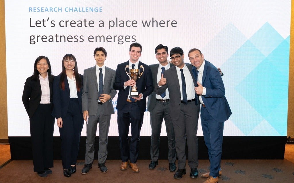 Waterloo students at the CFA Institute's Research Challenge in Poland holding their award