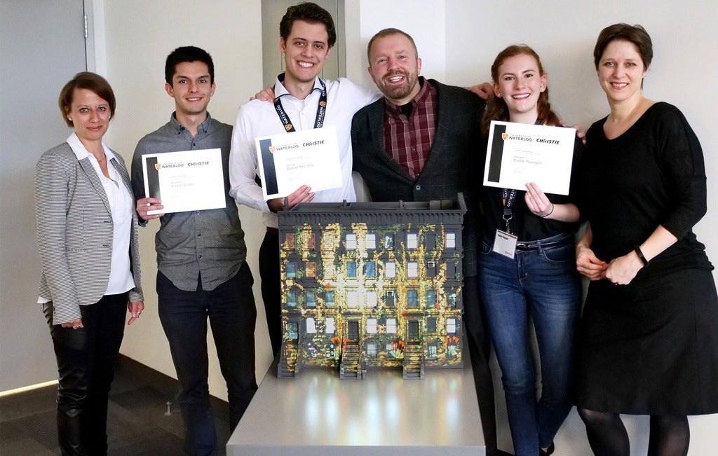 Winners of the Christie Design Awards smile at the camera.
