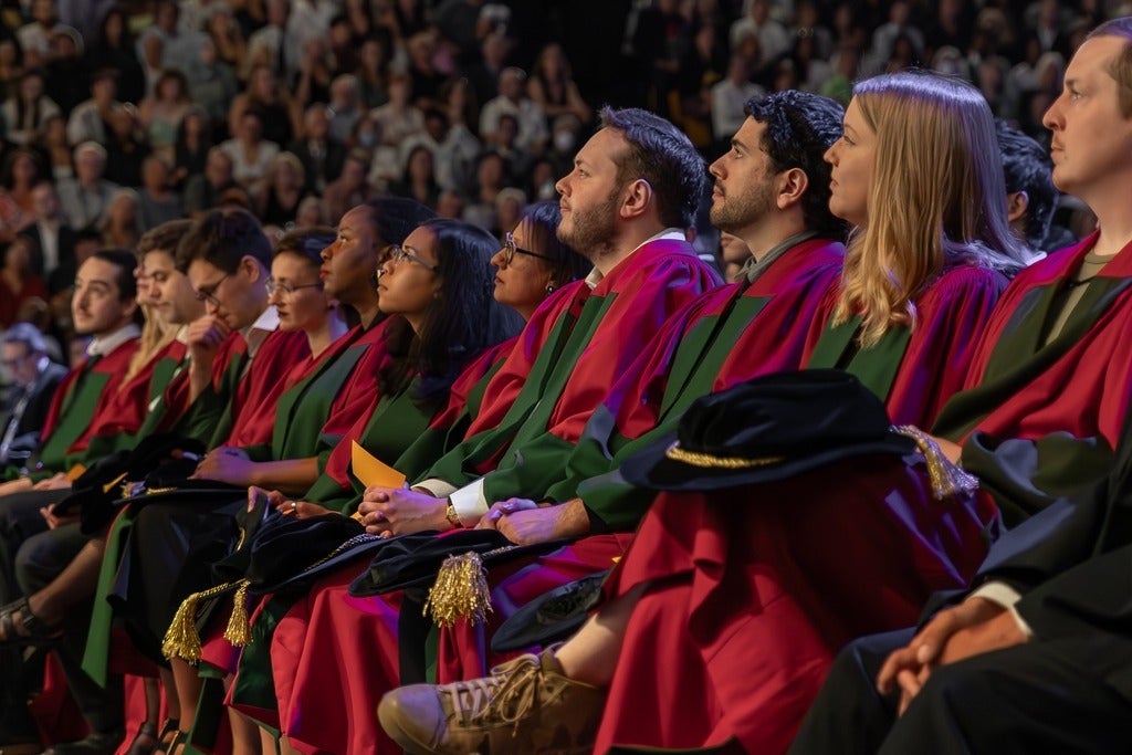 Group of Waterloo doctoral students sitting in front room at convocation