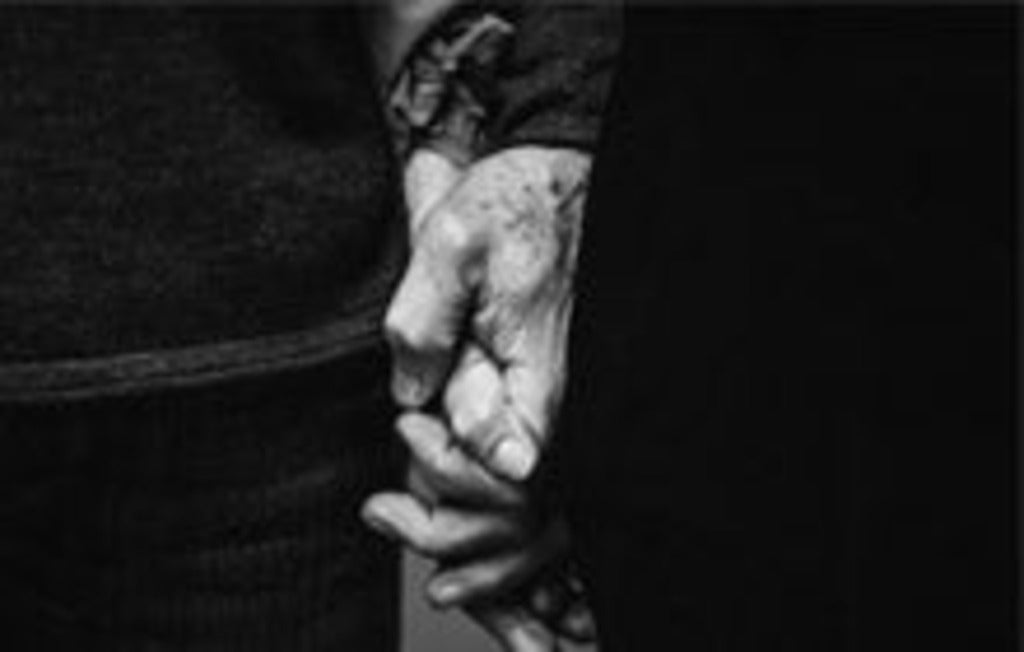 Senior couple holding hands