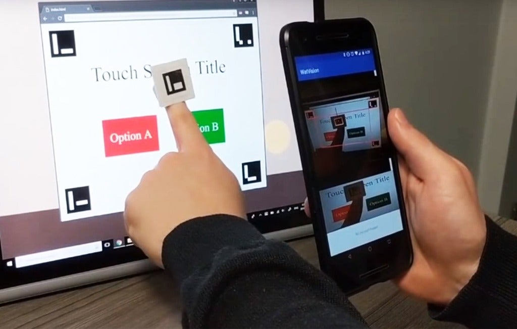 Finger pointing to a computer screen