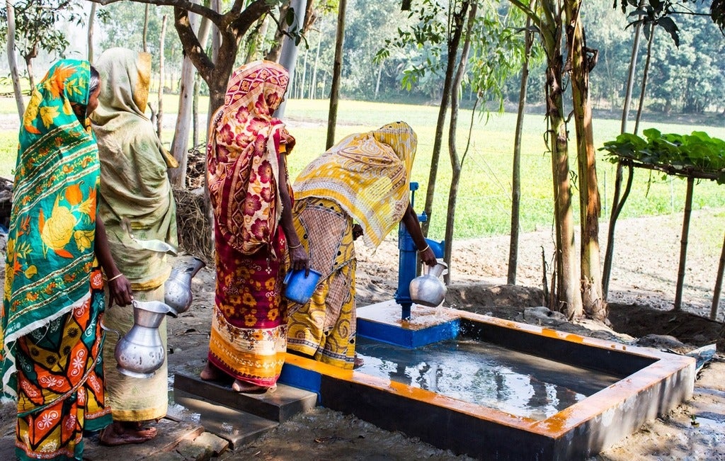 Water pump being used by women in Bangladesh
