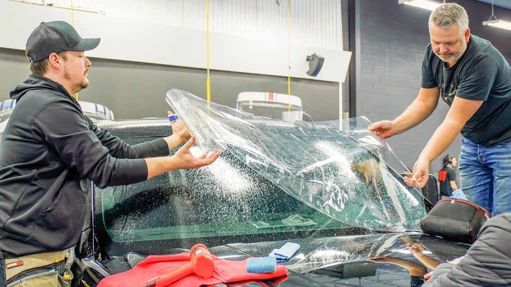 ExoShield being installed on a vehicle by two installers