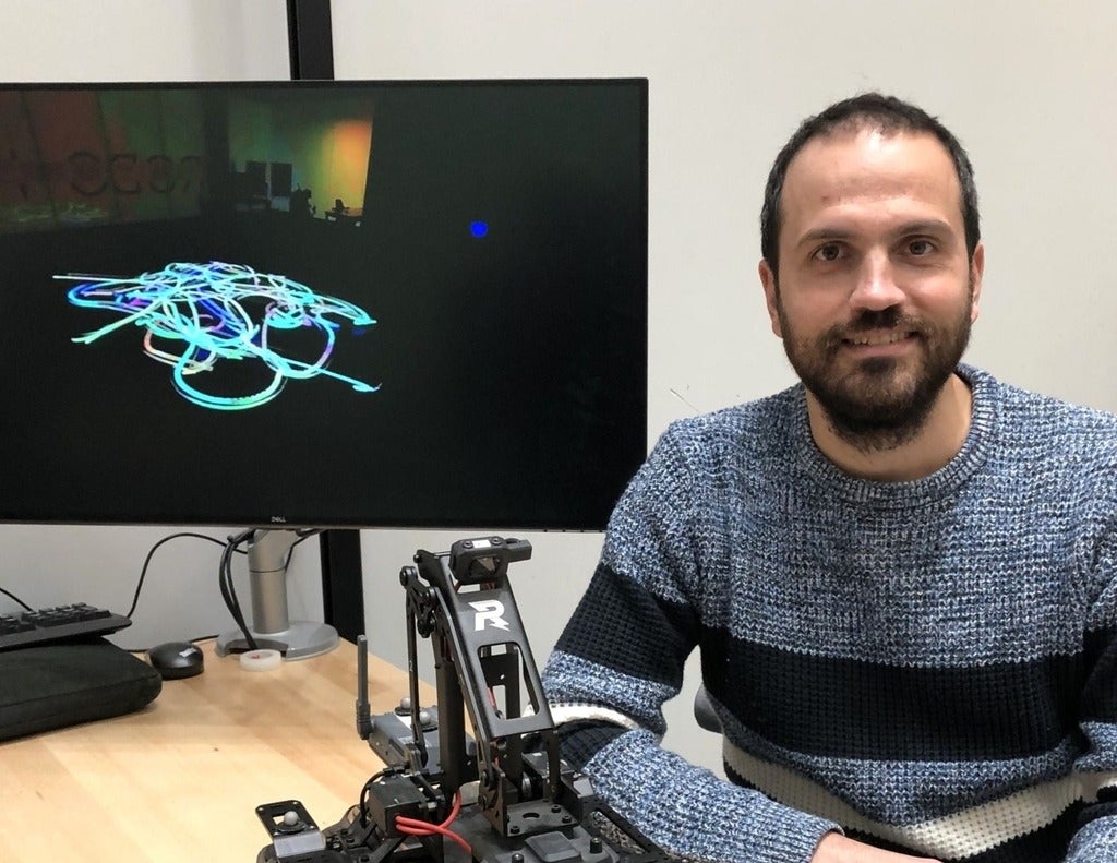 Dr. Gennaro Notomista, a University of Waterloo professor, with one of the robots that creates paintings inspired by music.