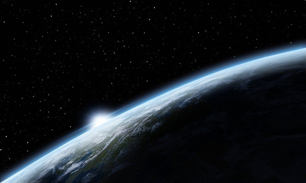 Earth in space showing sunrise