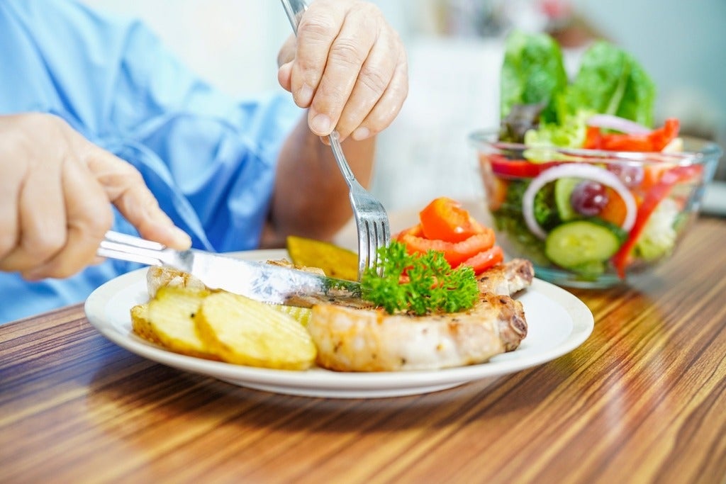 A senior person eating a healthy meal.