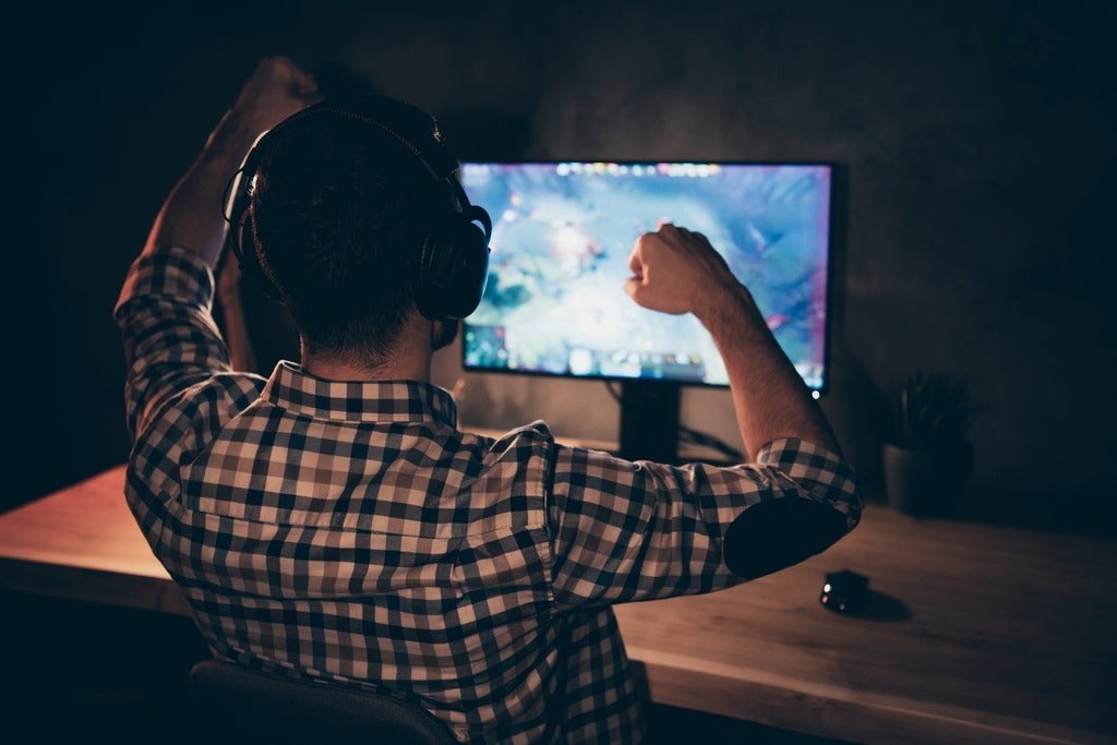 Rear view of a man playing a VR game
