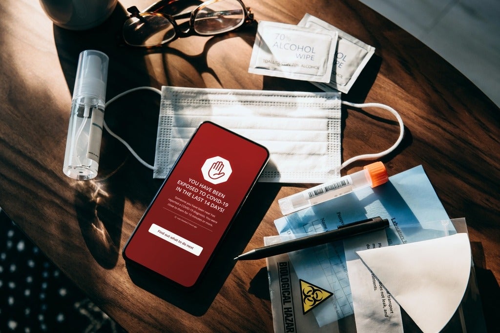 Covid-19 contact tracing app on smartphone showing the user have been exposed to Coronavirus infection.