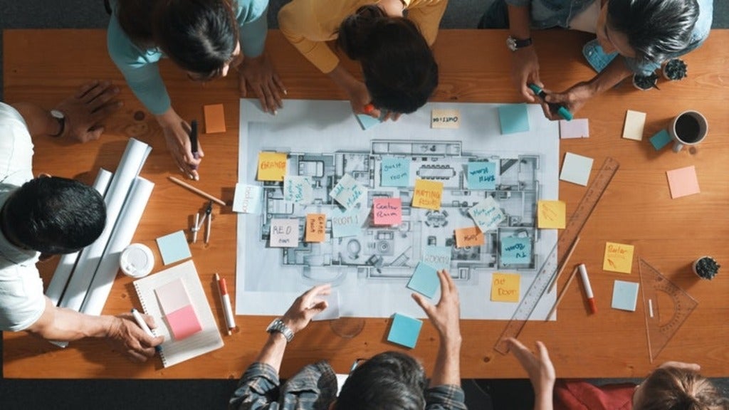 Aerial view of people writing and planning by using sticky notes to brainstorm idea. T