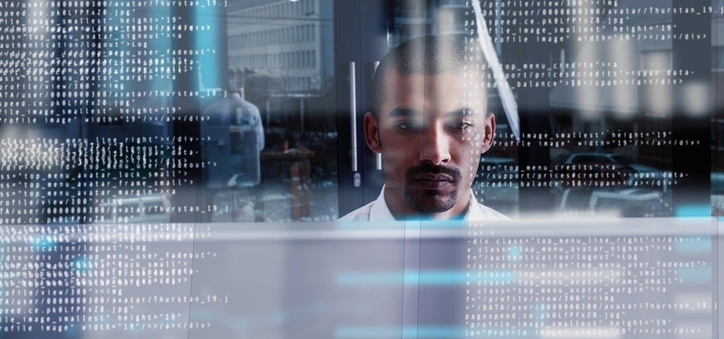 Computer programmer looking through data