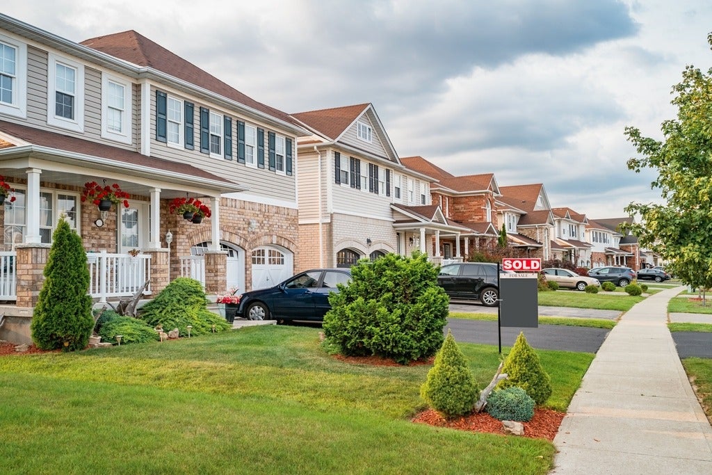  Row of new homes and SOLD sign in Brantford Ontario Canada.