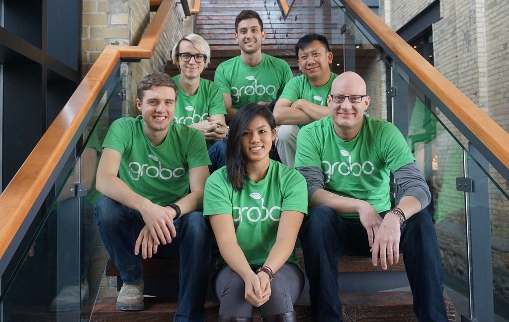 Grobo team sitting on a staircase