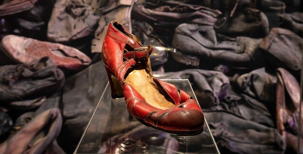 A woman's red shoe in a glass case