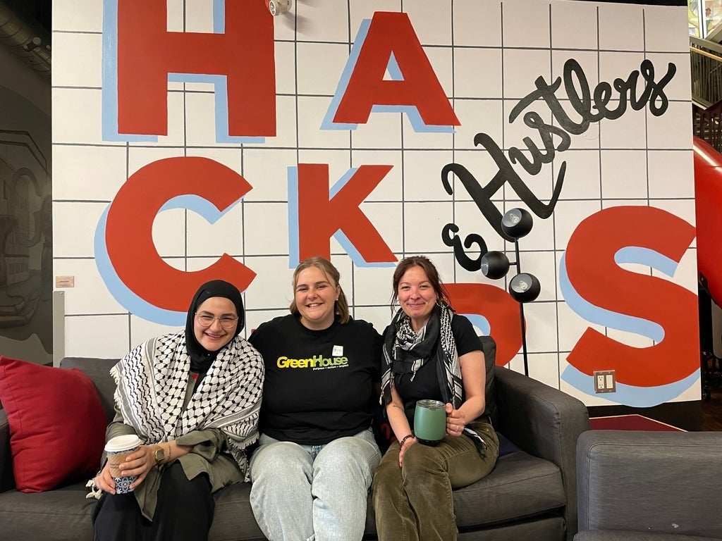 Malak Sameh, Erin Hogan and Lily Viggiano sitting inside the Communitech building