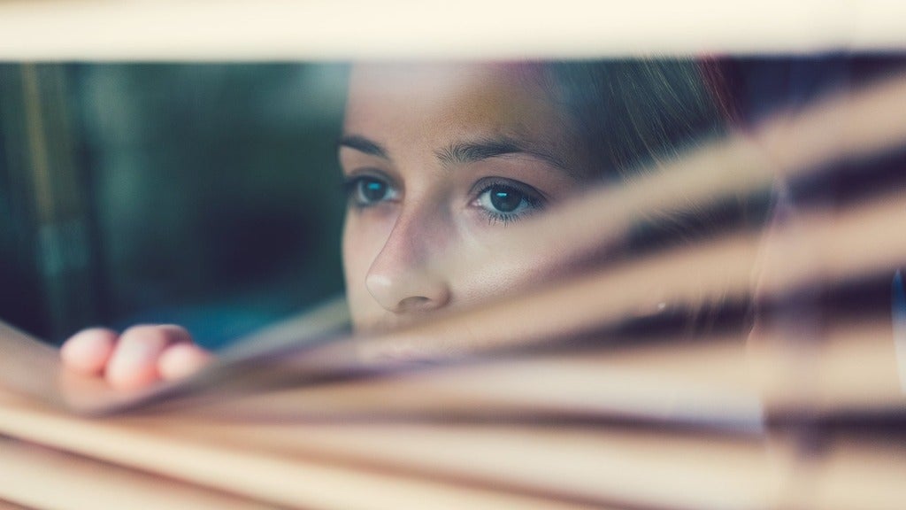 Person looking anxiously out the window