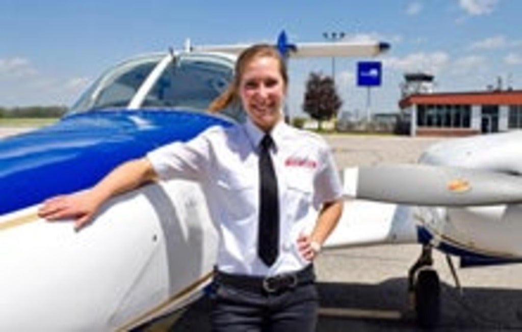 Jessalyn standing in front of plane