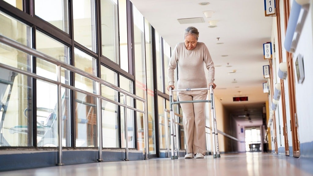 Older person with walker in hallway