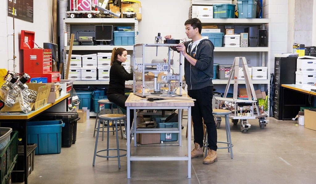 Two students working on robotics