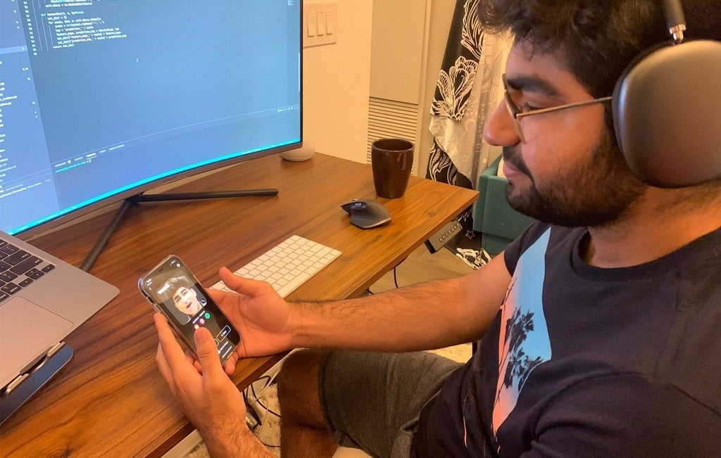 Parshant Utam looking at the Wombo app on his phone