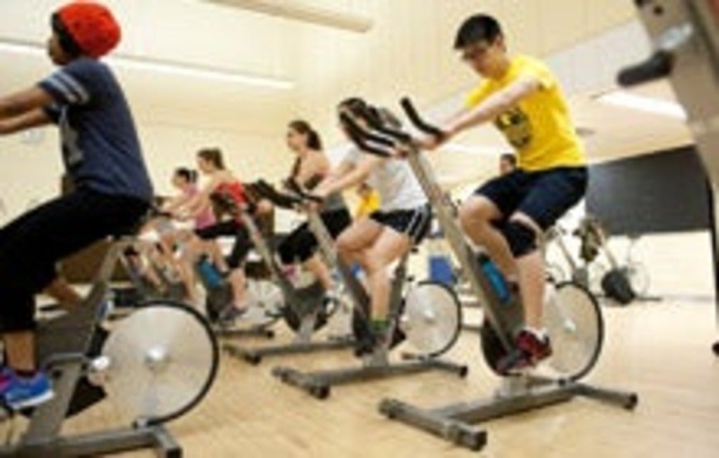 David Huang participating in a spin class on campus