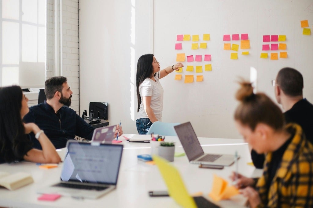 People working in team project office setting