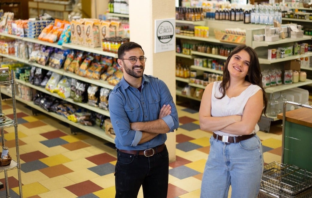 Two Waterloo alumni standing in the middle of a grocery store
