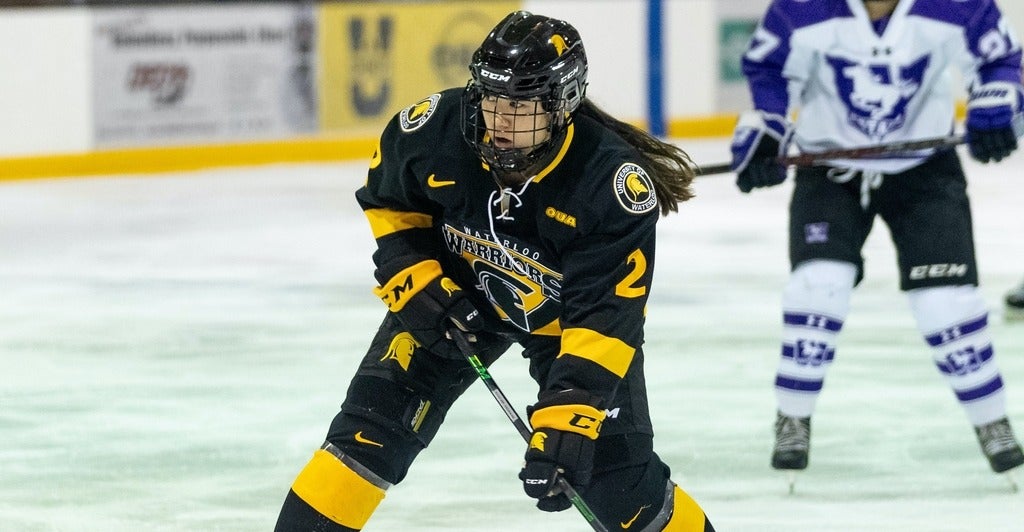 Trisha Cho on the ice in hockey gear