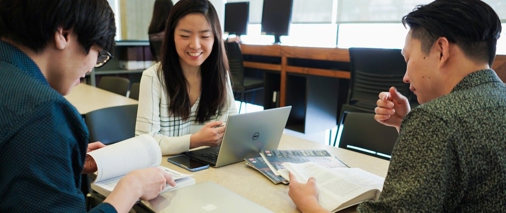 Students work in a team around a table
