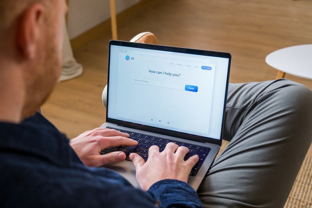 Person types on laptop