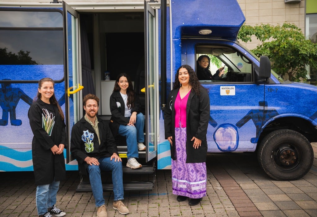 People in front of mobile lab. 