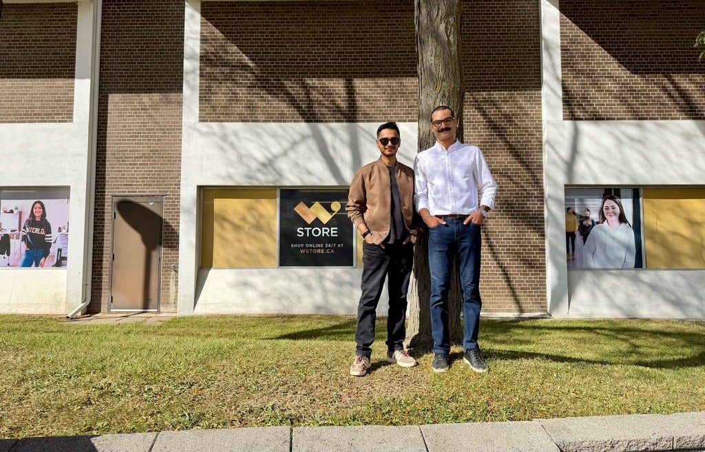 Two students in front of W Store sign