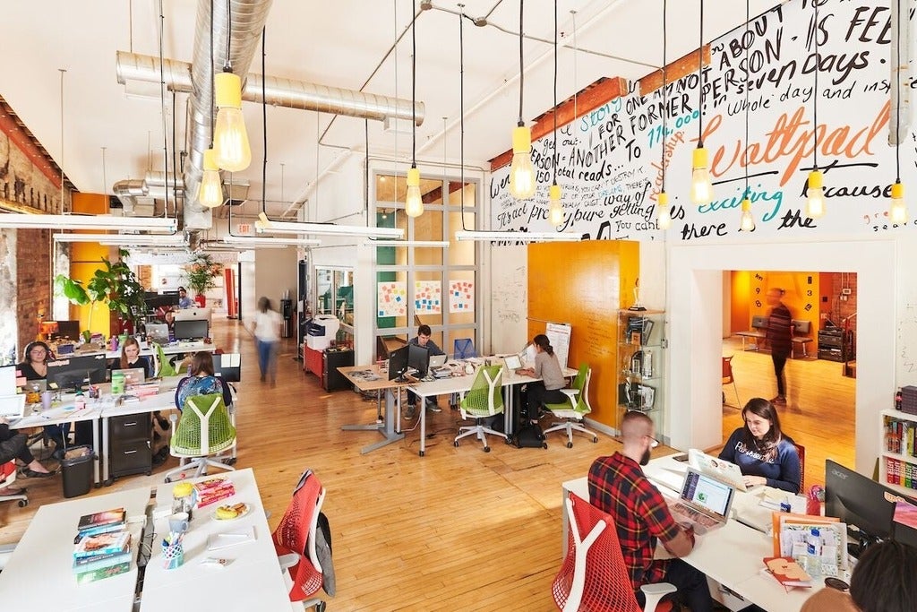Photo of the Wattpad studio office with employees on their laptops 