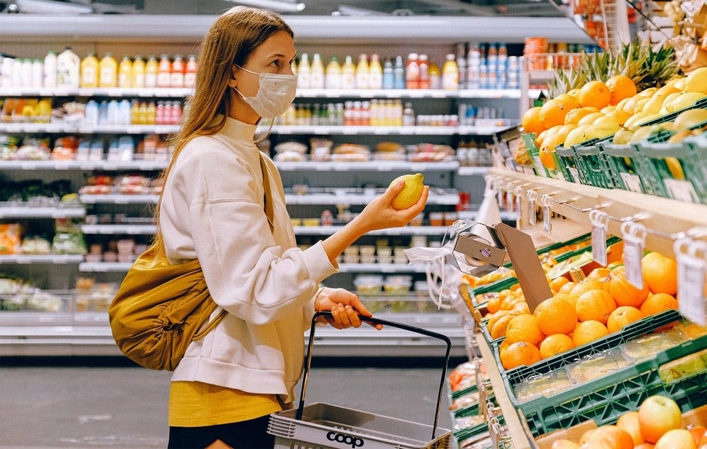 Woman wearing mask grocery shopping