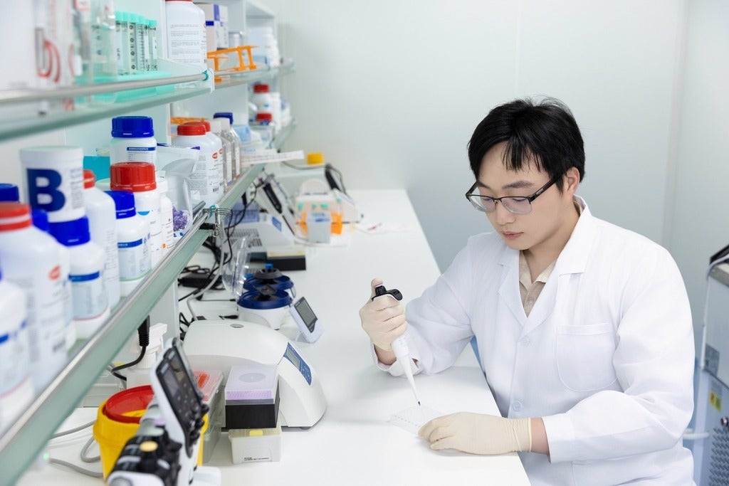 scientist in lab coat working in a laboratory
