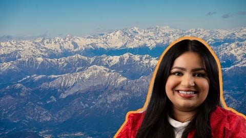 woman's smiling face with snowy mountains in background