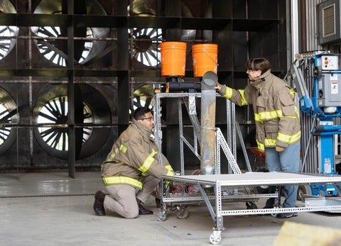 Vinny Gupta and Beth Weckman adjust some test equipment inside the Waterloo Fire Research Lab