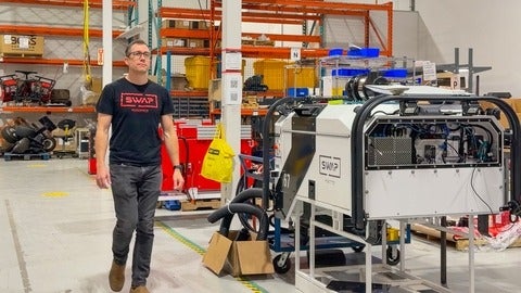 Tim Lichti walking through manufacturing warehouse where Swap Robotics is built