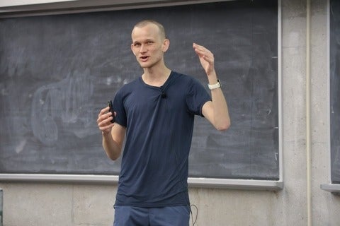 Vitalik Buterin lectures in front of a blackboard 