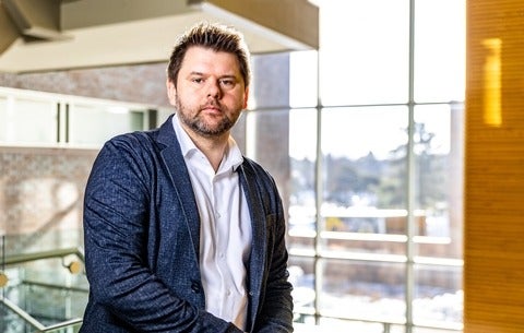 Adam Presslee in the atrium of the School of Accounting and Finance