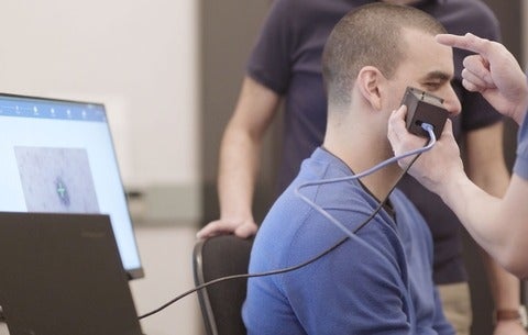 Alex Wong using his AI imaging device